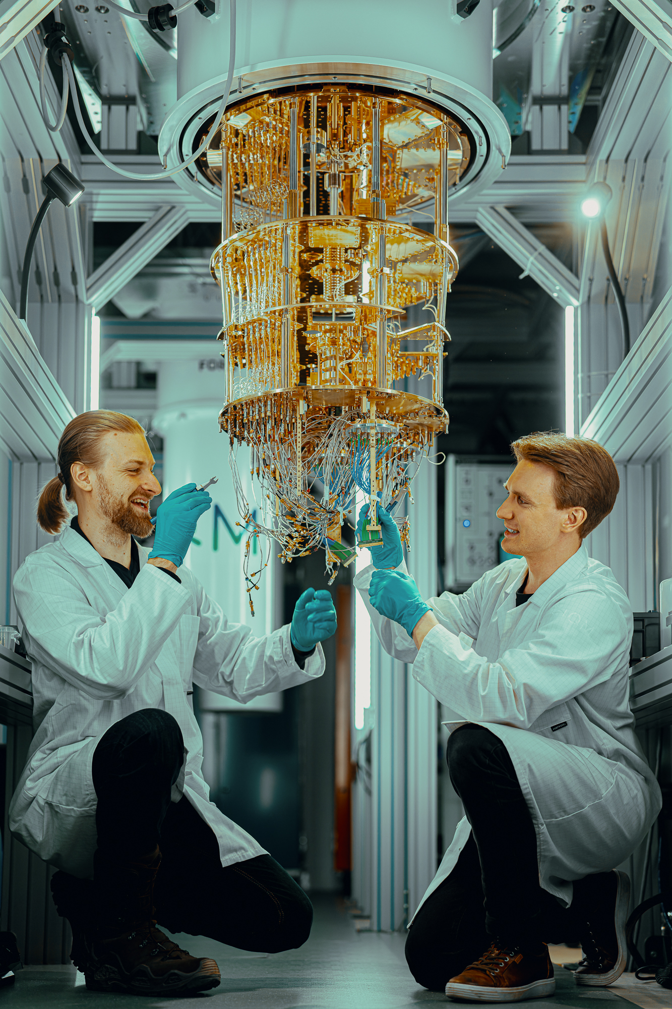 Vladimir Milchakov and Juho Hotari loading a Bluefors dilution refrigerator at IQM Quantum Computers